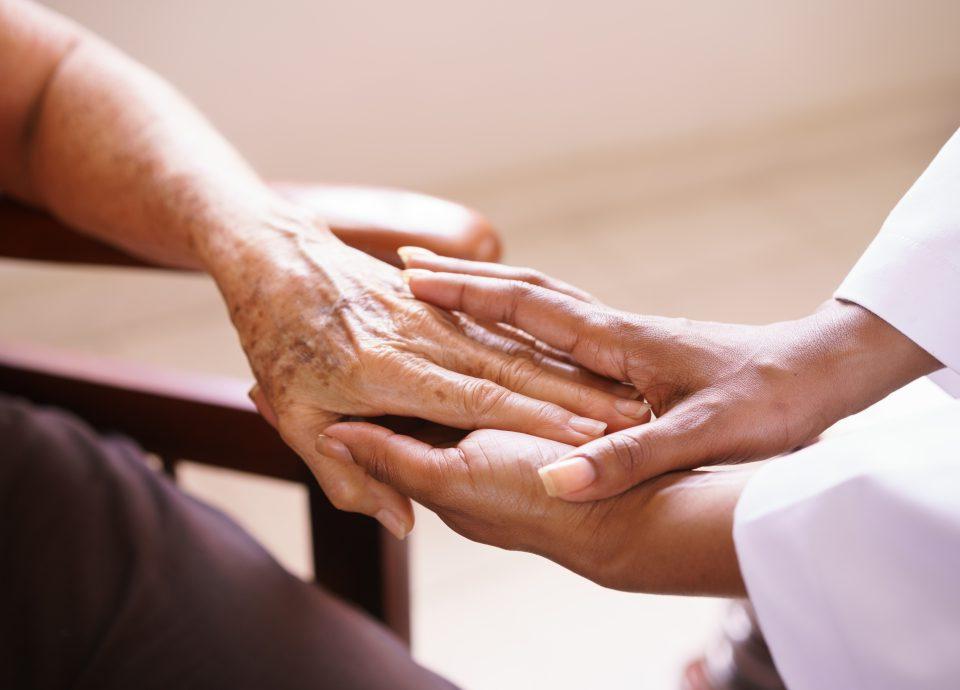 Senior Woman Talking With Doctor In Hospice