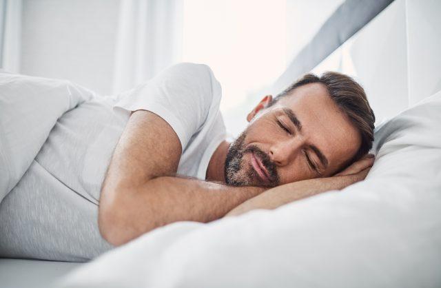 man sleeping in bed